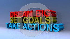 Dream big set goals take actions on blue