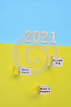 Dream big, work hard and make it happen text written on torn colorful paper with 2021 background