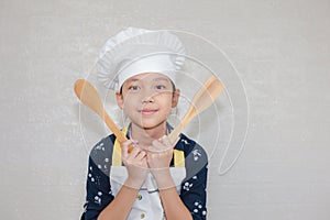 Dream careers concept, Portrait of Happy Kid chef looking at camera with blurred background