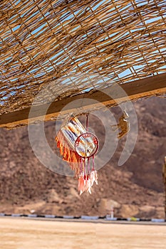 A dream catcher against the backdrop of the desert and mountains in Egypt