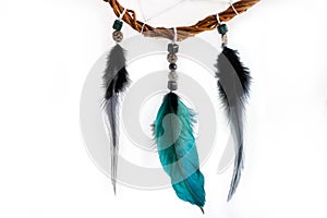 Dream catcher with colourful feathers from the vine. Close-up of feathers on the white background.