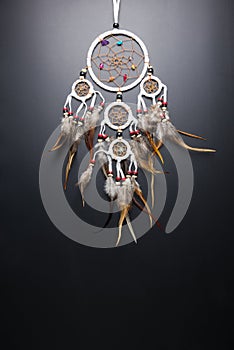 Dream catcher with feathers threads and beads rope hanging spiritual folk american native indian amulet isolated on black