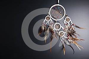 Dream catcher with feathers threads and beads rope hanging spiritual folk american native indian amulet isolated on black