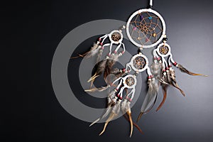 Dream catcher with feathers threads and beads rope hanging spiritual folk american native indian amulet isolated on black