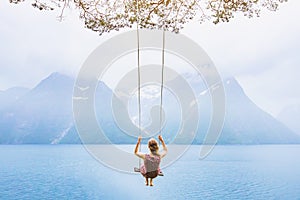 Dream concept, beautiful young woman on the swing photo