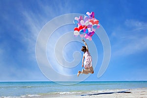 Dream concept, girl flying on multicolored balloons