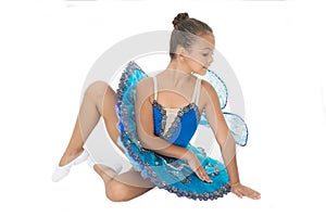 Dream of every girl to become famous ballet dancer. Kid blue dress with ballet skirt white background isolated. Child