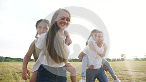 Dream holiday concept. happy family fun walks in the park with kid. parent father and mother carry children with sister