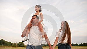 Dream holiday concept. happy family fun walks in the park with kid. parent father and mother carry children with sister