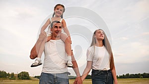 dream holiday concept. happy family fun walks in the park with kid. parent father and mother carry children with sister