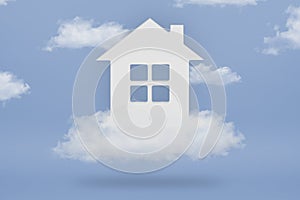 Dream House. The concept of buying a dream home. White house in the clouds on a blue sky background. Purchase of real