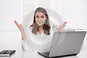 Dream job: successful smiling businesswoman sitting at desk with