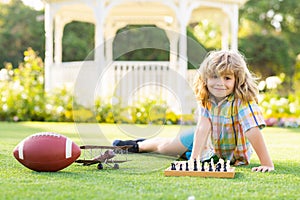 Dream kids and childhood concept. Little child play chess. Kid playing board game. Thinking child brainstorming and idea