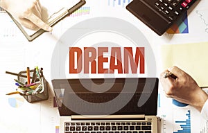 Dream TEXT.Business team hands at work with financial documents