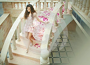 Dream wedding, beautiful bride, walking down stairs with flowers