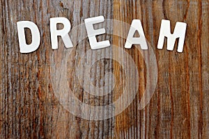 Dream word on wooden background