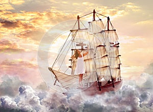 Dream world. Sailing ship with beautiful girl on board floating among wonderful fluffy clouds