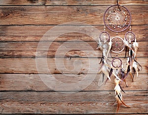 Dreamcatcher, american native amulet on wooden background. Shaman