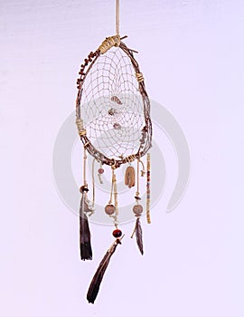 A dreamcatcher dangles in the air