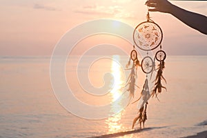 Dreamcatcher, on sunrise sea background, magical indian shaman