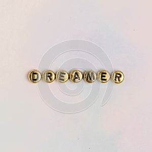 DREAMER beads text typography on pastel photo