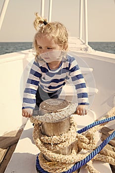 Dreamer kid in striped marine shirt. small sailor on boat. let dream come true. summer vacation. child dream to be