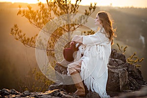 Dreamer woman meeting sunrise at the mountains photo