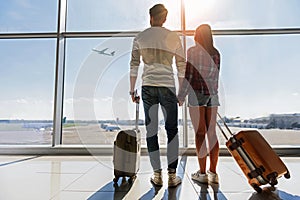 Dreamful loving couple looking at flying plane