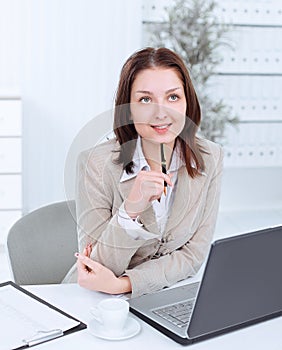 Dreaming business woman sitting at her Desk