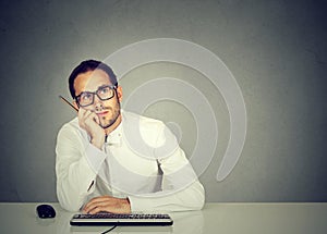 Dreaming employee sitting at table