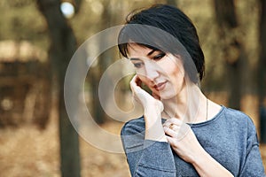 Dreaming girl portrait, yellow leaves on background, autumn city park, fall season