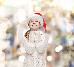 Dreaming girl in santa helper hat