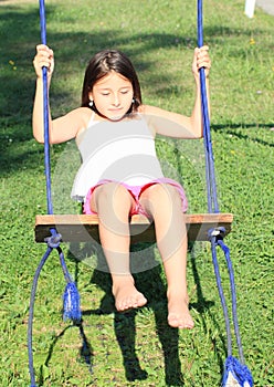 Dreaming girl on swing