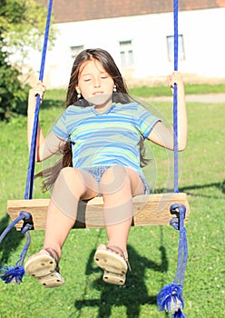 Dreaming girl on swing