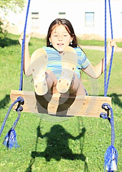 Dreaming girl on swing