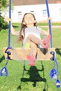 Dreaming girl on swing