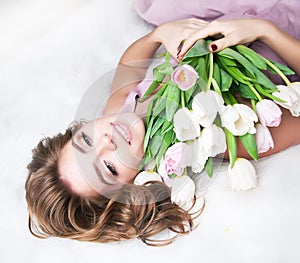 Dreaming lovely young girl with bunch of flowers