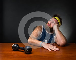 Dreaming man and a dumbbell