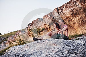 Dreaming mood. Two person sitting on the rock and watching gorgeous nature