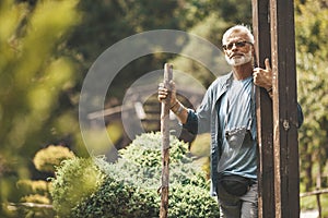 A dreaming pensioner is walking in nature. Loneliness retired, widower. Melancholy, lonely memories