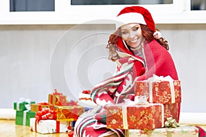 Dreaming Positive Winsome Sexy Smiling Santa Helper With Christmas Present Holding Cellphone in Hands Talking