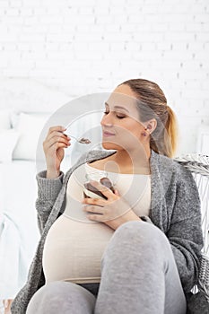 Dreaming pregnant woman devouring cocoa spread