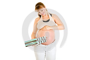 Dreaming pregnant woman holding present for baby