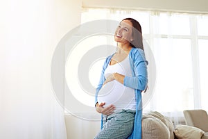 Dreaming pregnant woman looking up