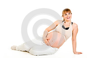 Dreaming pregnant woman sitting on floor