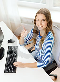 Dreaming teenage girl with computer at home
