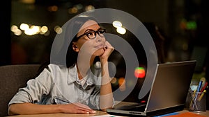 Dreaming woman sitting front laptop, tired of boring work, inattentive employee