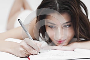 Dreaming woman writing on a notebook