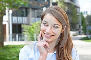 Dreaming young woman with blond hair outside