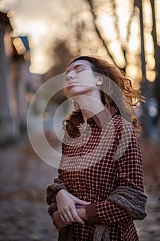Dreaming young woman with spectacular curly red ginger hair